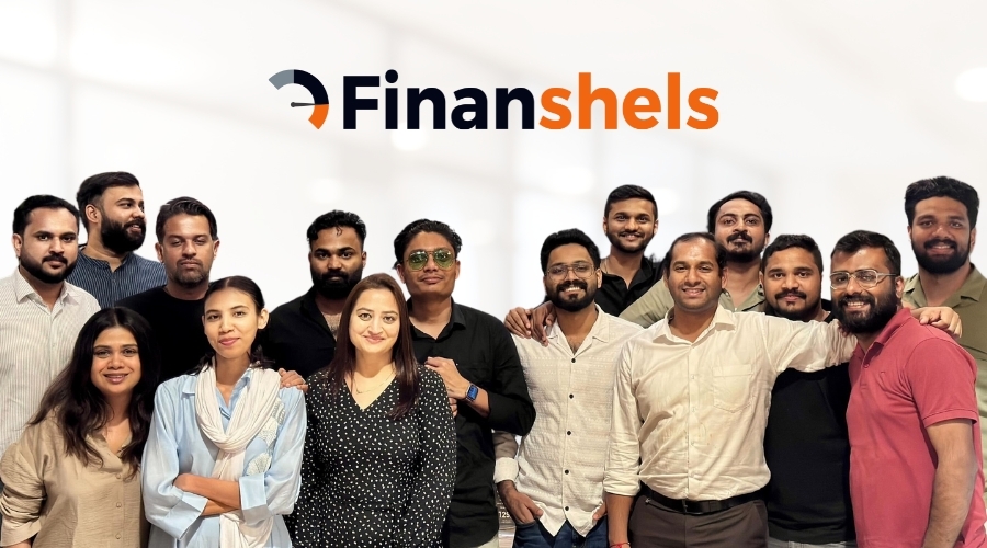Team photo of the Finanshels team, a diverse group of professionals standing together, showcasing collaboration and leadership in finance.