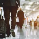 Business traveler walking through airport terminal, symbolizing rising corporate mobility in the MENA region.