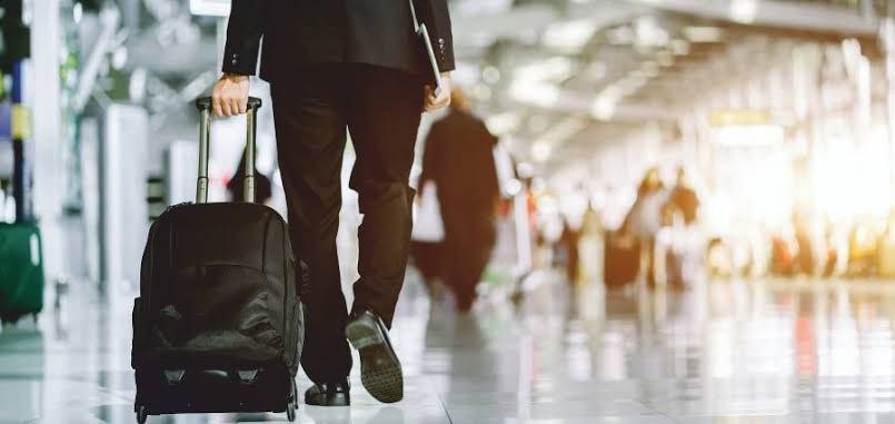 Business traveler walking through airport terminal, symbolizing rising corporate mobility in the MENA region.