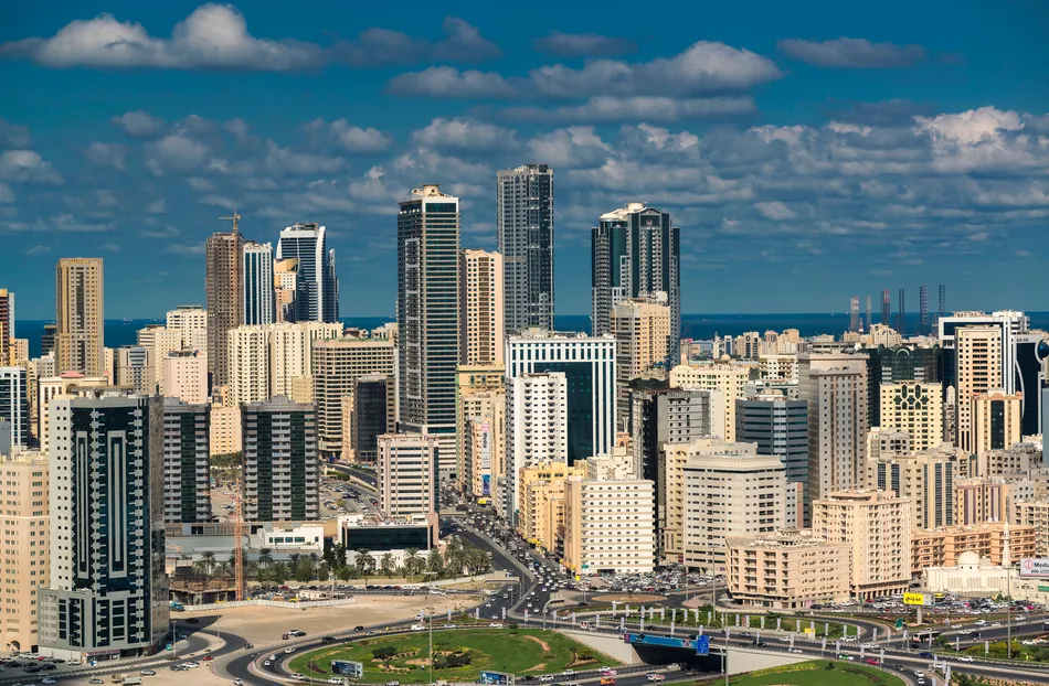 Sharjah skyline and residential developments representing AED7 billion in real estate transactions during July 2026